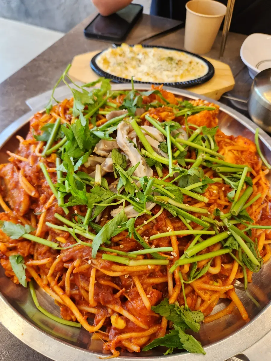 Boneless monkfish stew topped with bean sprouts and minari