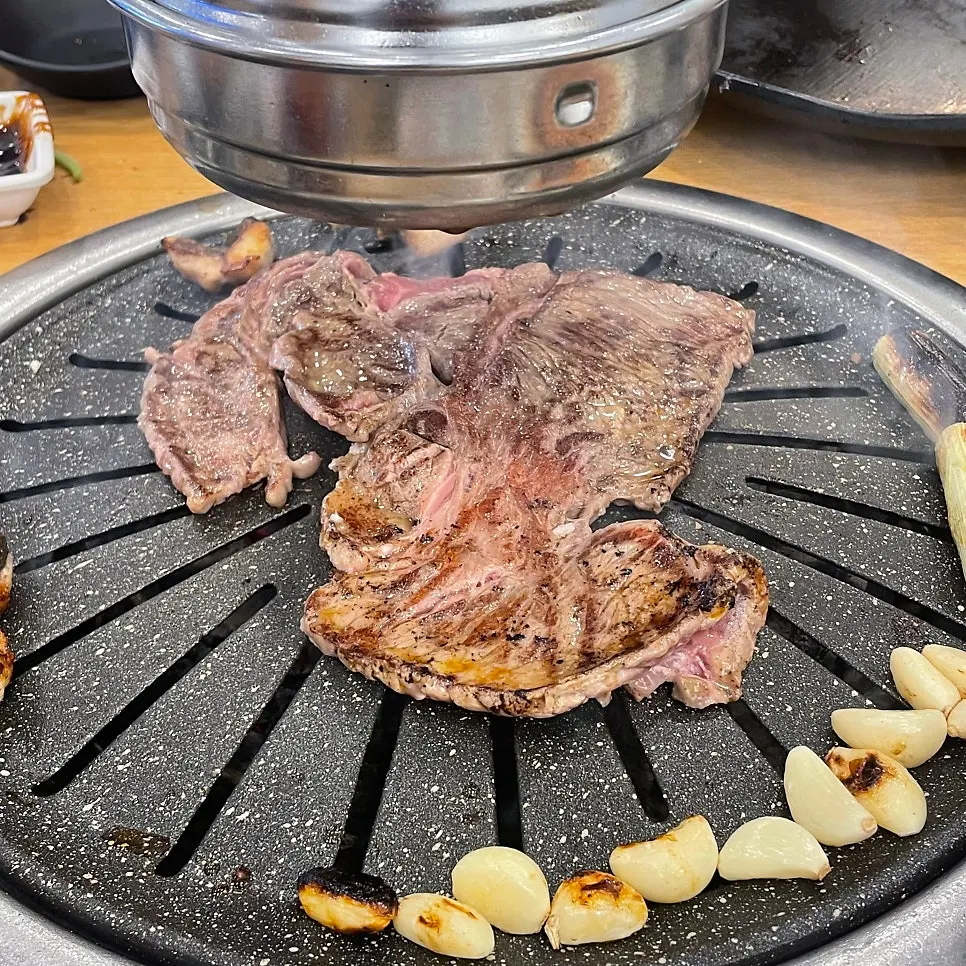 Sirloin grilling over charcoal