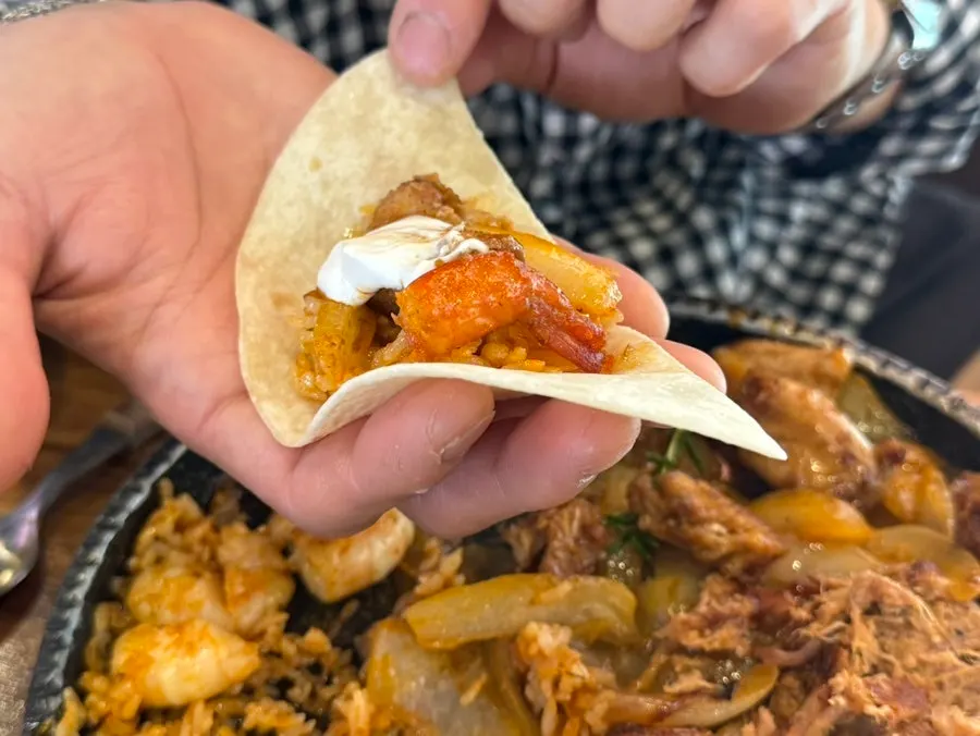 Tortilla topped with shrimp and fried rice