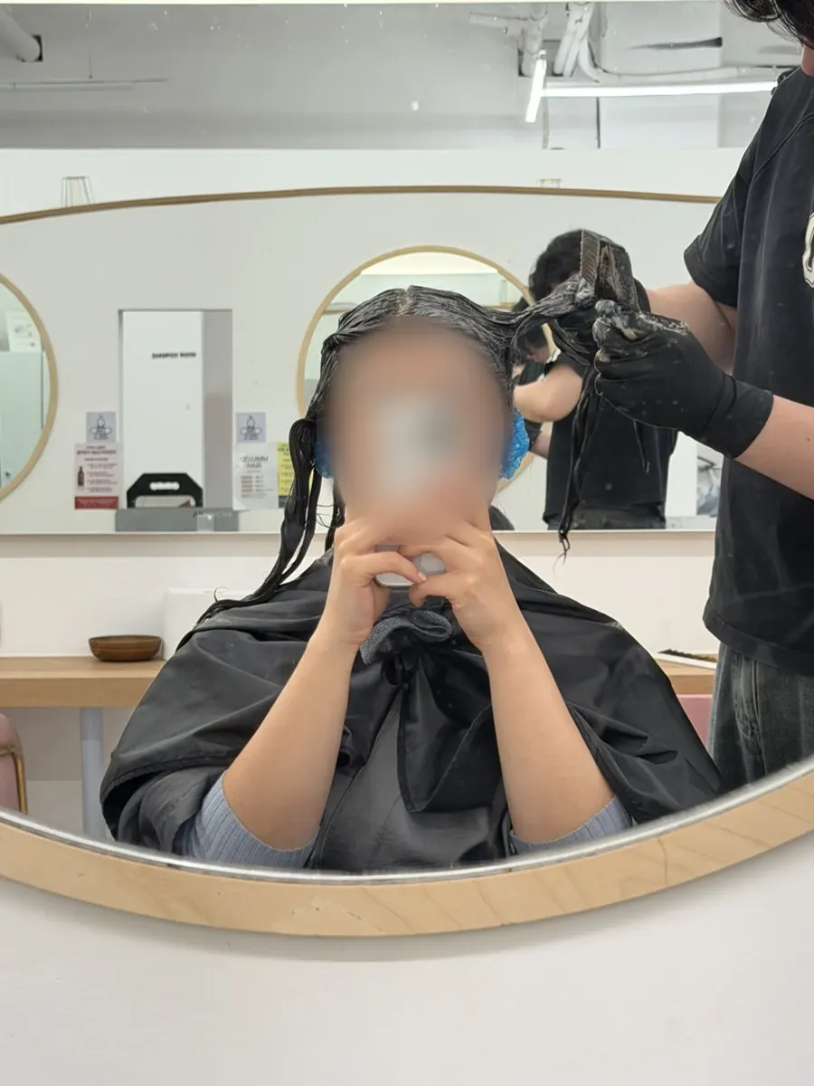 Dark brown dye being applied to hair