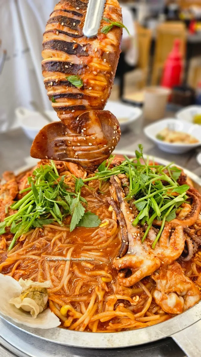 Seafood jjim topped with a whole squid