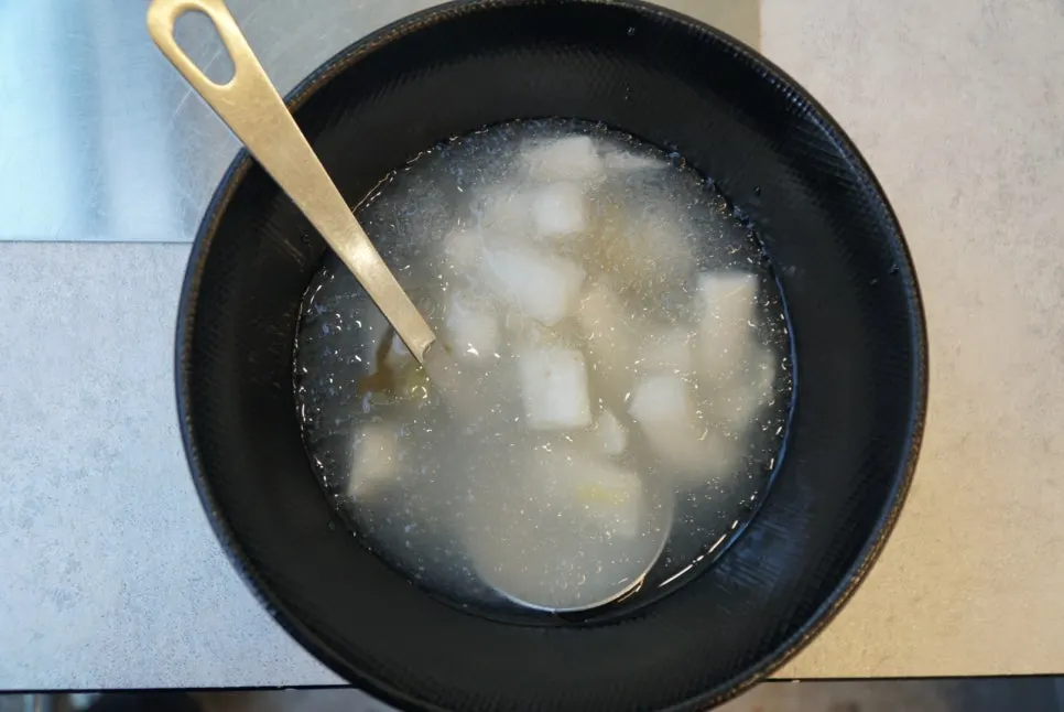Cauldron-lid kimchi pork belly cooking further at the table