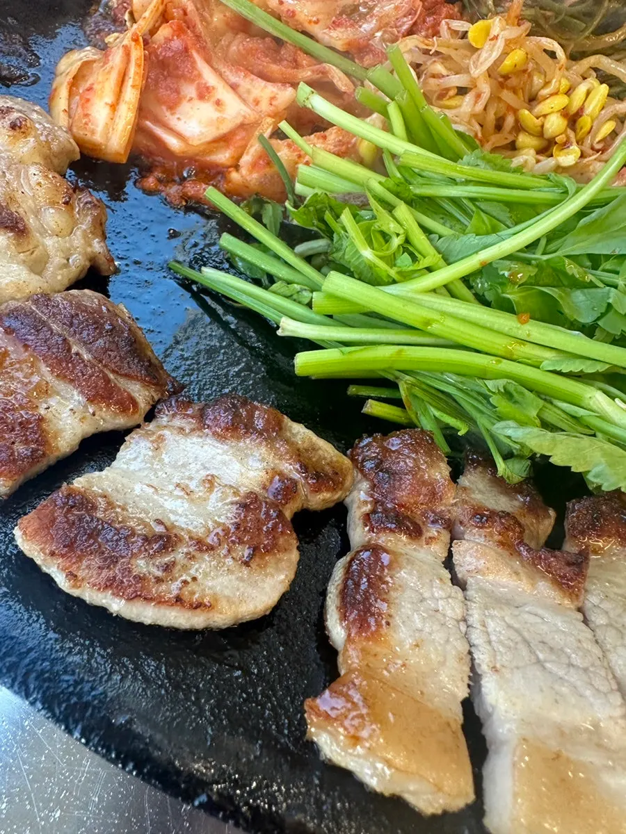 Pork belly and accompaniments on a pot lid