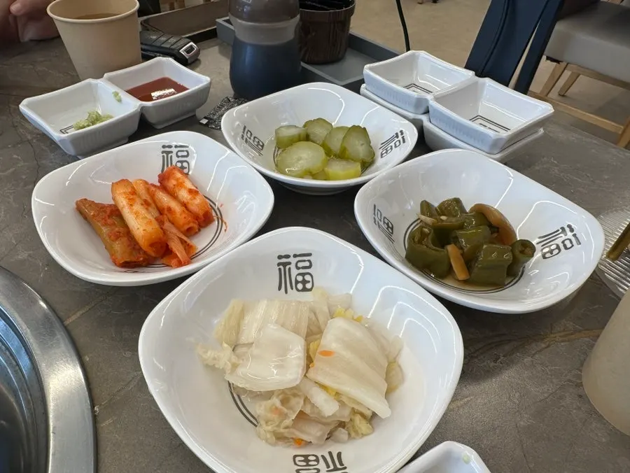 Basic side dishes: white kimchi, green onion kimchi, pickles, pickled peppers