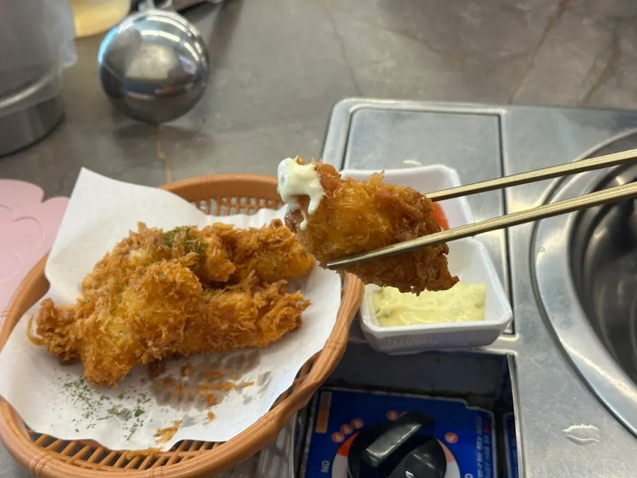 Two dipping sauces, chili and tartar, for the fried monkfish