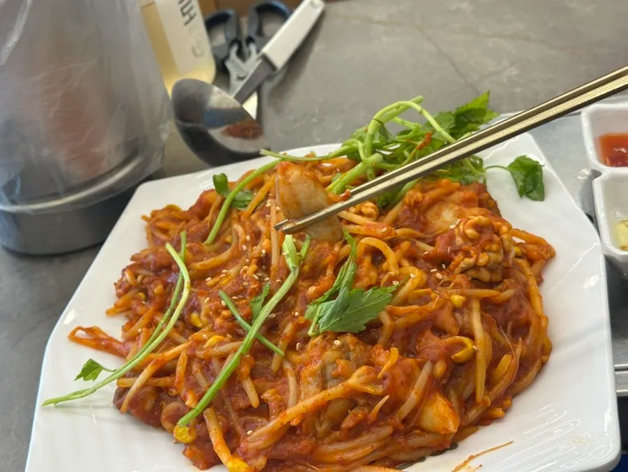 Agu-jjim topped with minari and bean sprouts