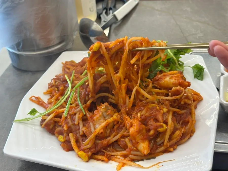 A plate of agu-jjim evenly coated in sauce