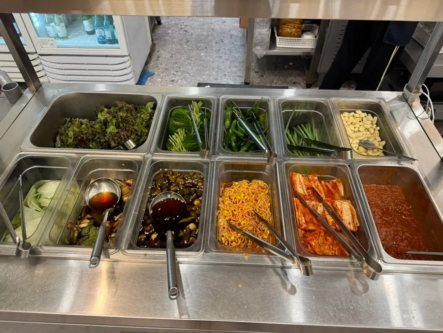 Neatly arranged side dish station at the self-serve bar