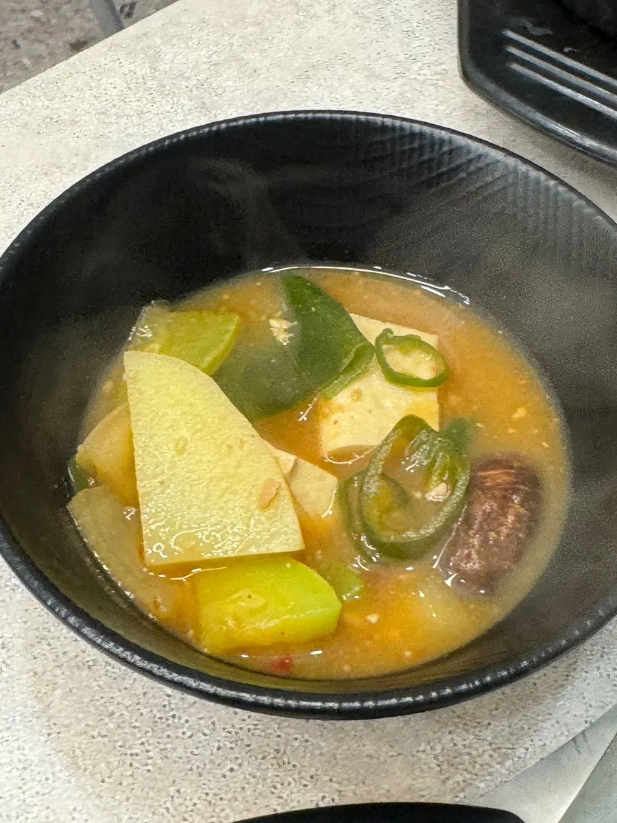 A bowl of doenjang jjigae with generous ingredients