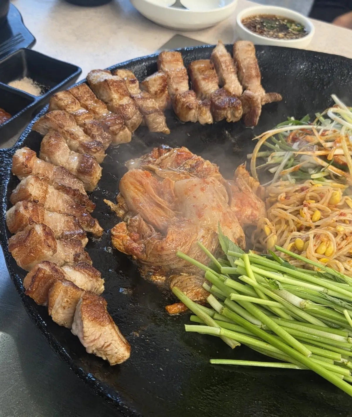 A fully grilled, golden-brown plate of kimchi pork belly
