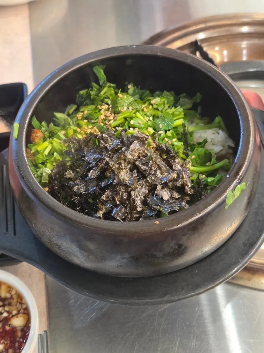 A bite of pork belly eaten with jjolmyeon
