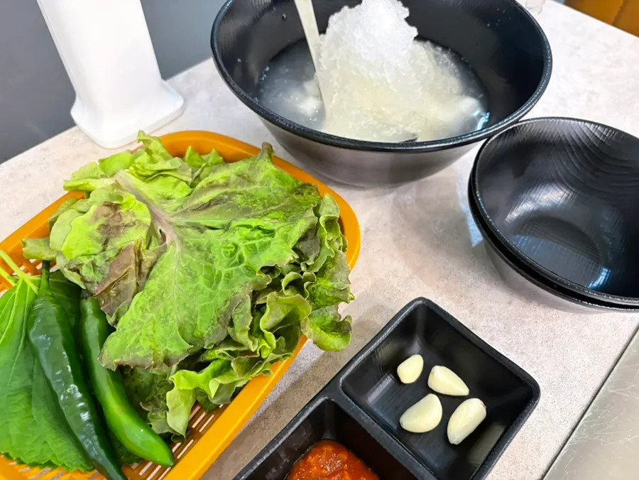 Basic table setting served after ordering kimchi pork belly