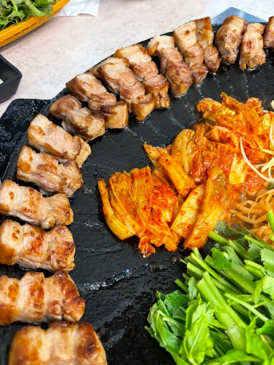 Pork belly pot topped with kimchi and vegetables