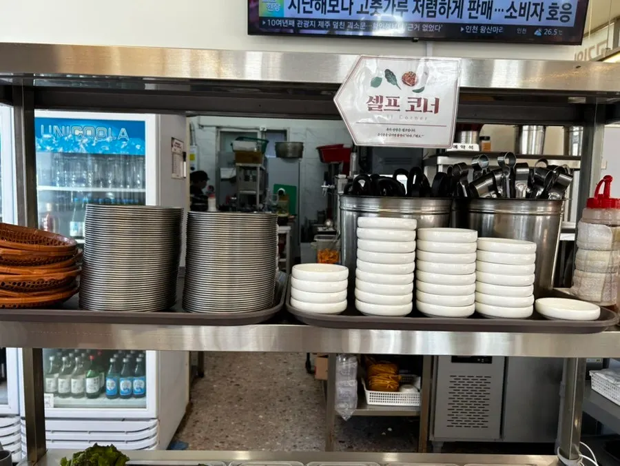 Self-serve bar plates of kimchi, bean sprouts, and other sides