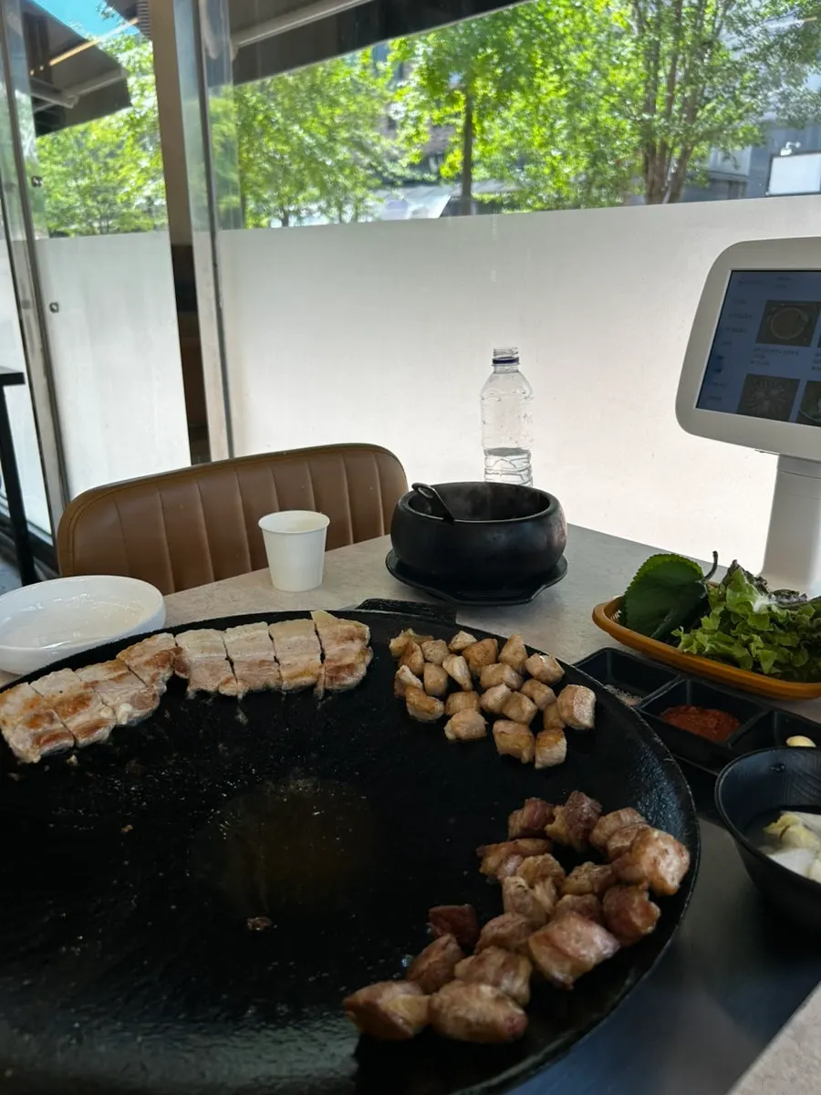 Pork belly arranged on a pot lid with the center left empty