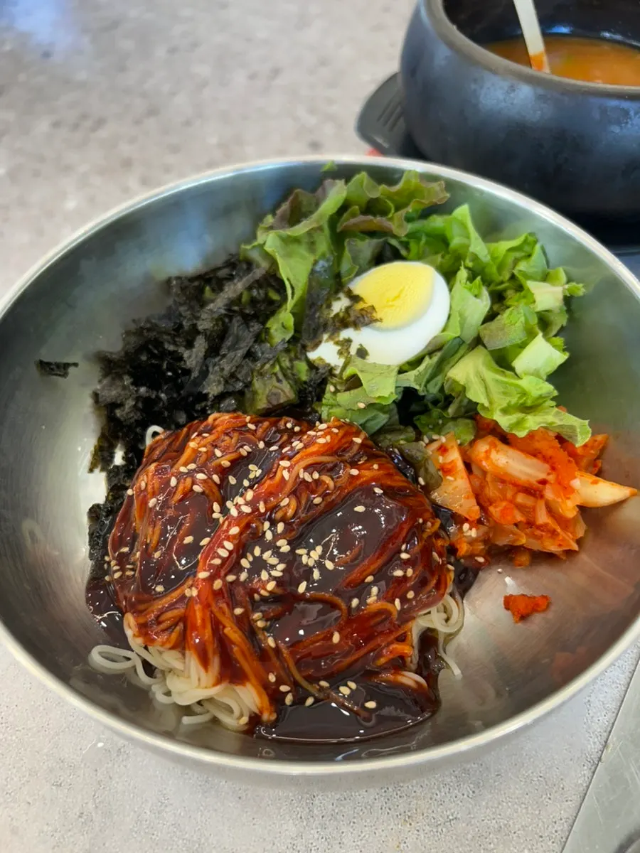 Bibim guksu served alongside the pork belly