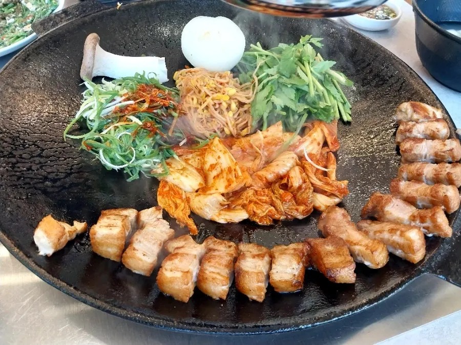 Pot-lid pork belly topped with finely sliced kimchi