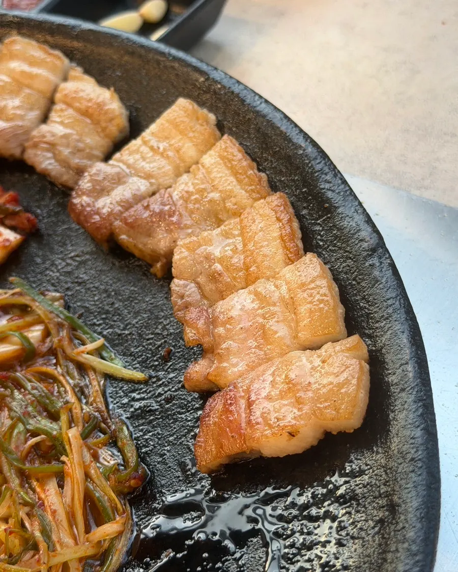 도톰하게 구워진 기본 김치 삼겹살 한 점