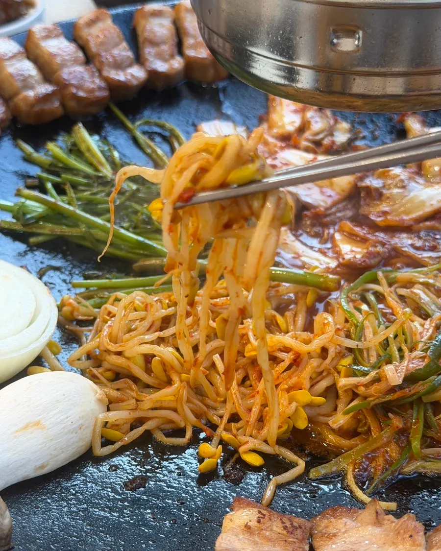 불판에 올려 데운 파채무침과 삼겹살
