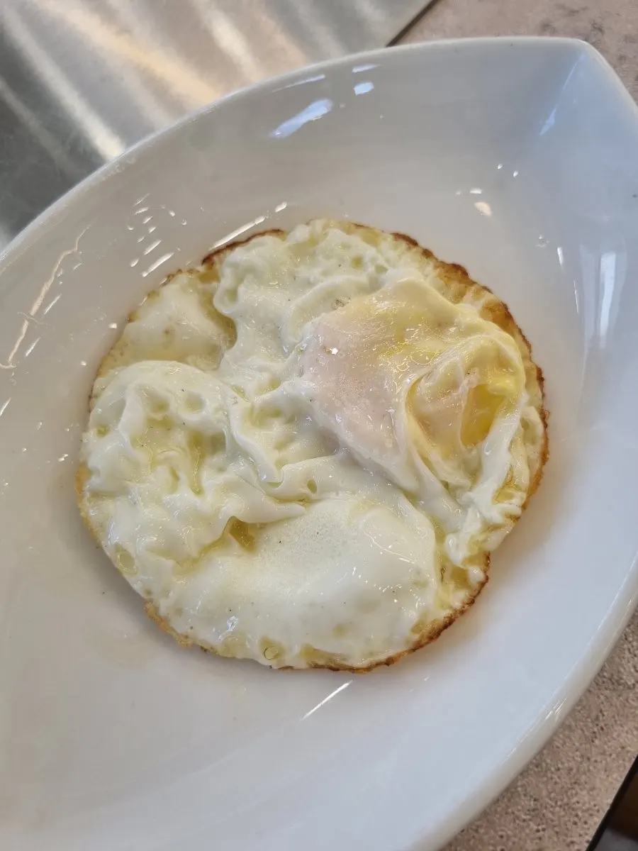 Complimentary fried egg served with side dishes