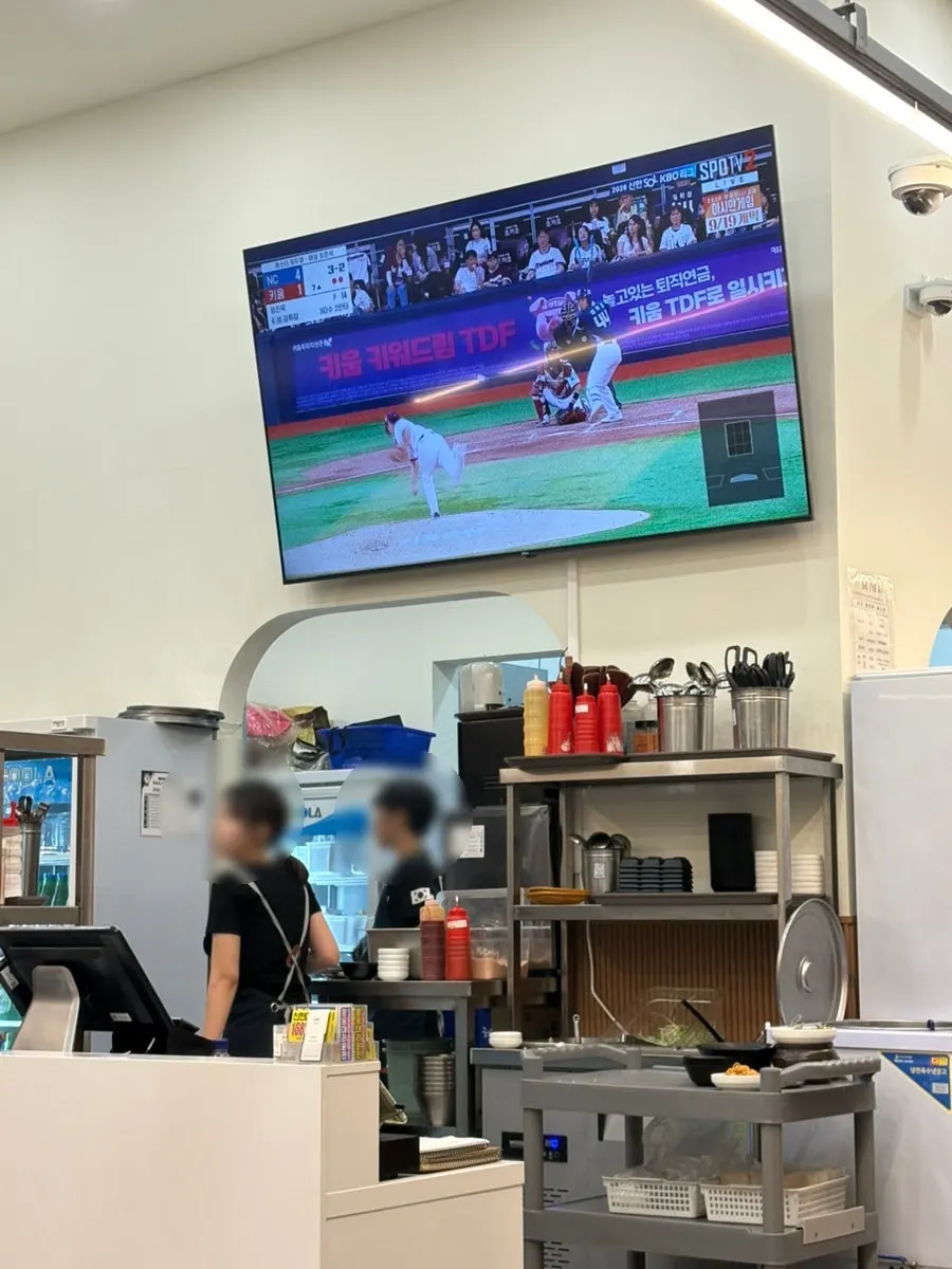 TV screen showing a baseball broadcast inside the restaurant