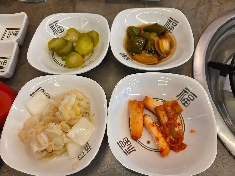 Basic side dishes served with the seafood hot pot