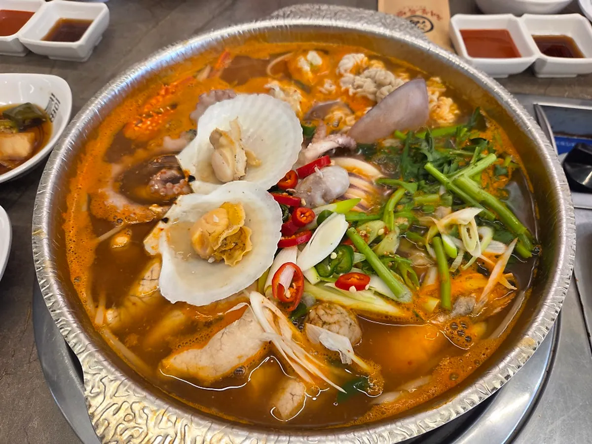 Full table with seafood hot pot, corn cheese and flat dumplings