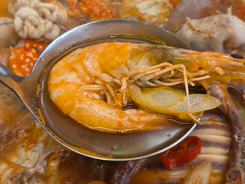 A large head-on shrimp filling the ladle