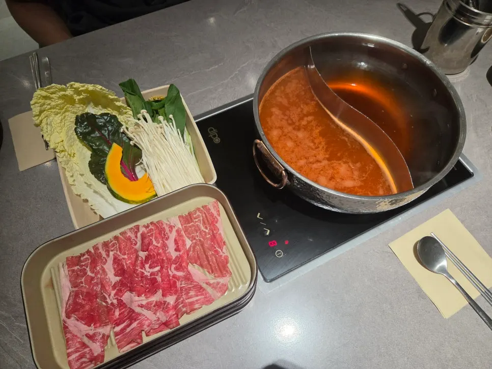 Shabu-shabu table setting with mild and spicy broths