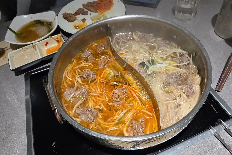 Adding vegetables and meat to shabu-shabu
