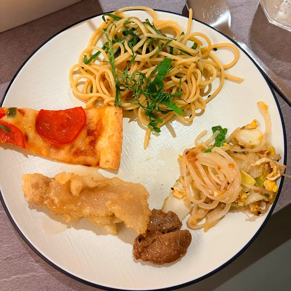 Plate of hot food dishes gathered from the salad bar