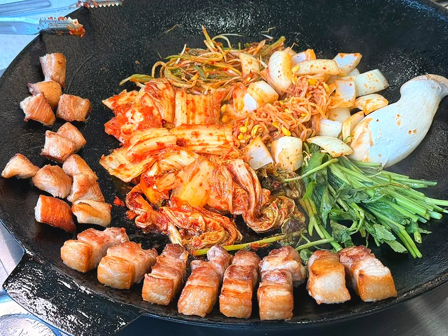 Meat served with minari and kimchi