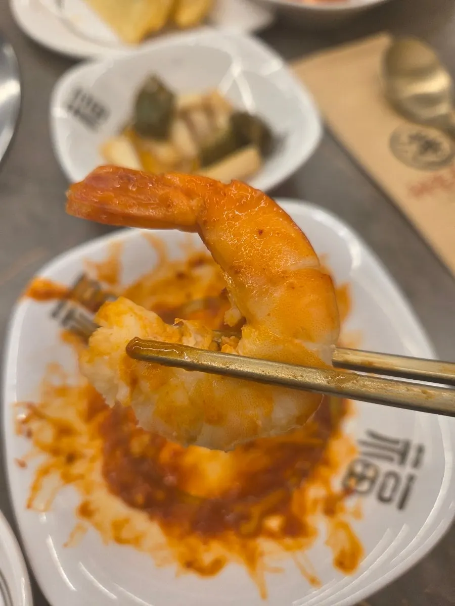 Plate of seafood stew with large, generous pieces of seafood