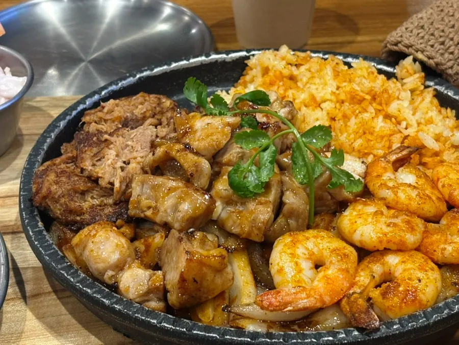 Pork, shrimp and bacon on the fajita grill plate