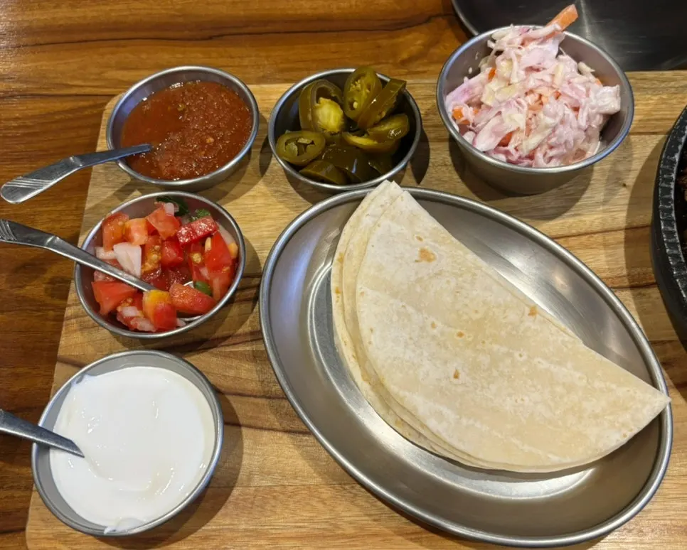 Tortilla topped with meat, vegetables and fried rice