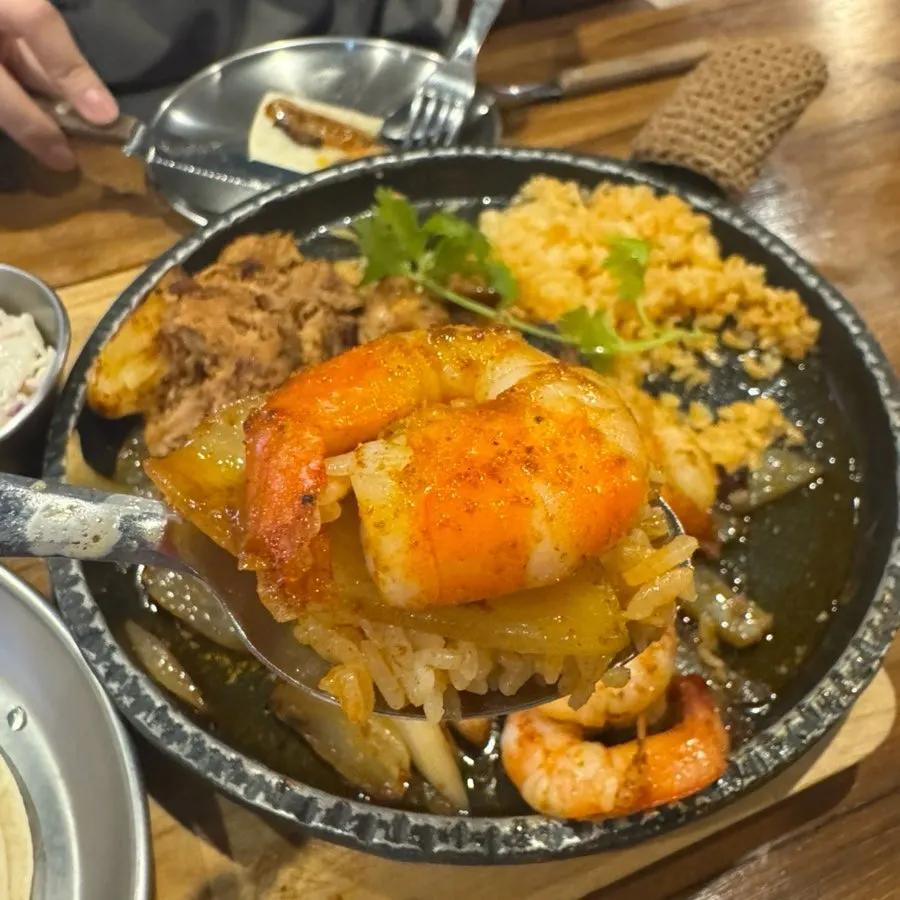 볶음밥과 고기, 새우를 함께 담은 접시