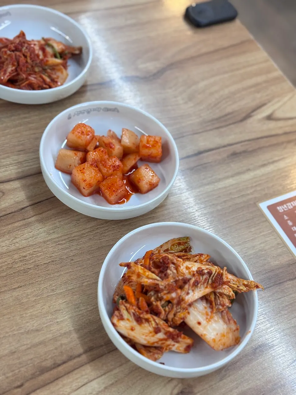 Fresh kimchi and diced radish kimchi at the self-serve bar
