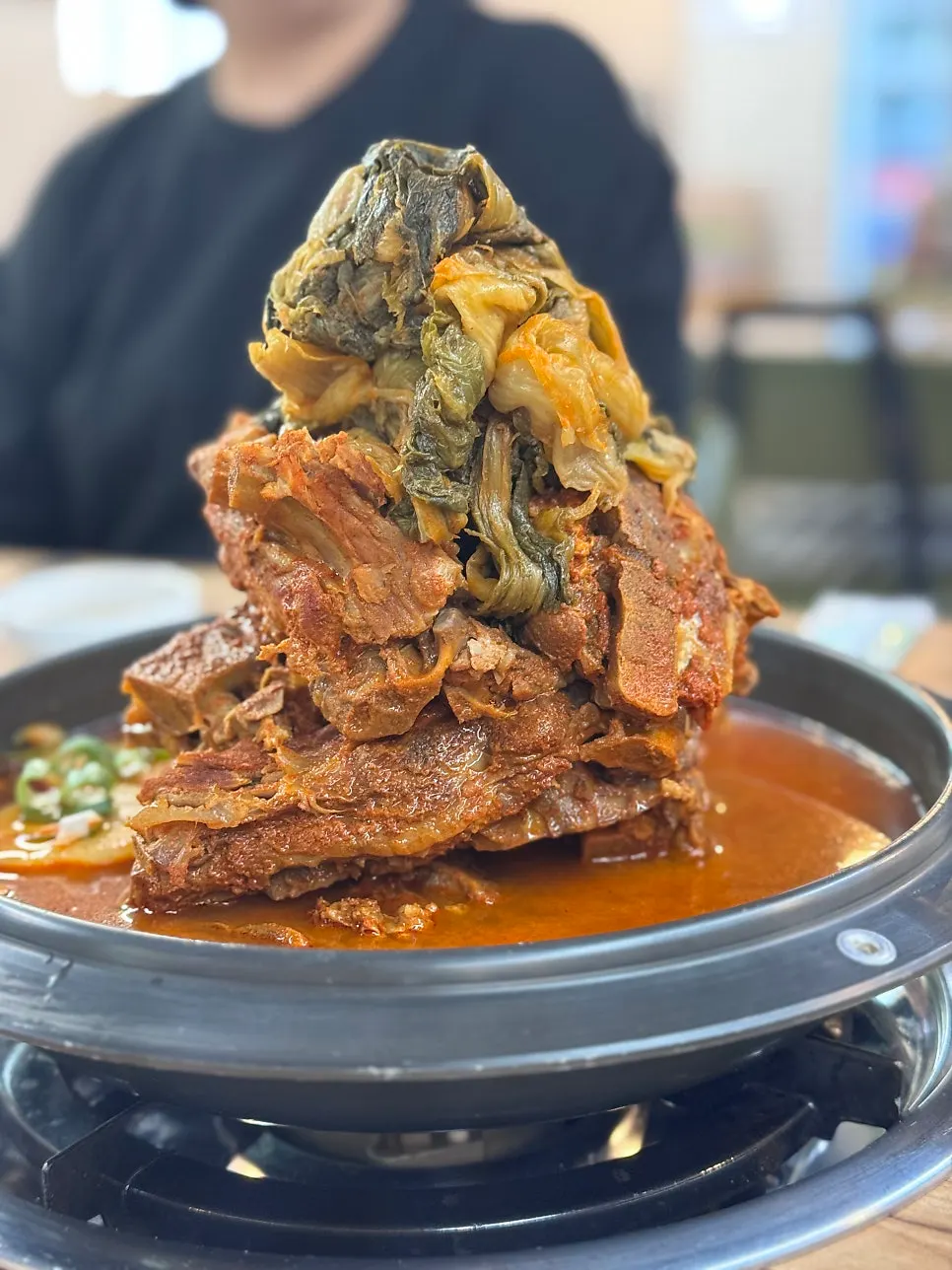 Gamjatang topped with ugeoji and perilla leaves