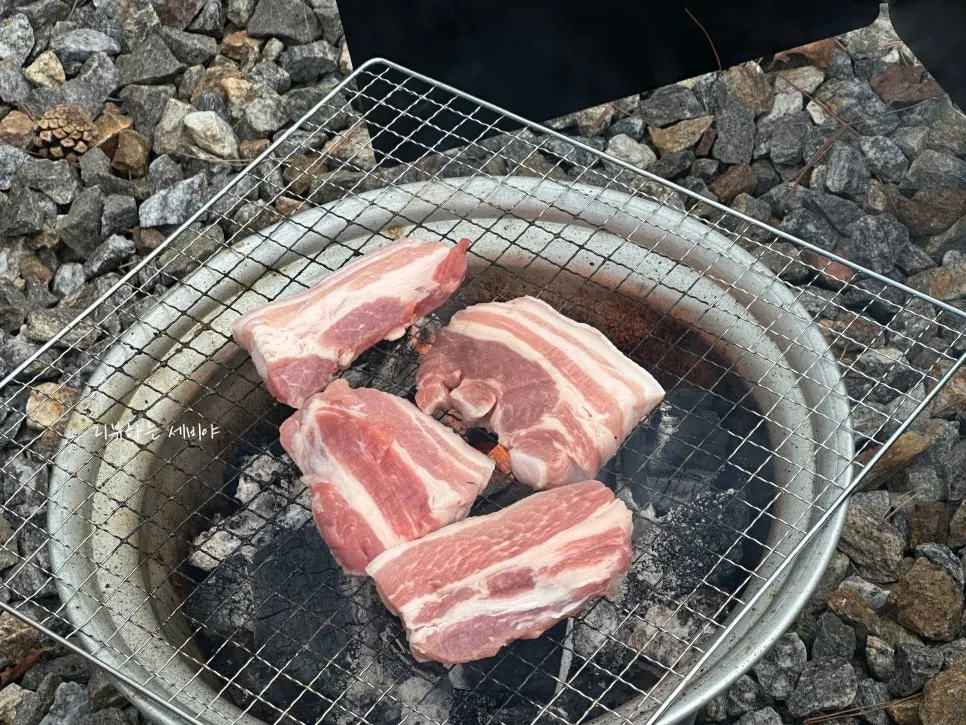 Fresh pork shoulder from Ari Chuksan grilled on a small brazier