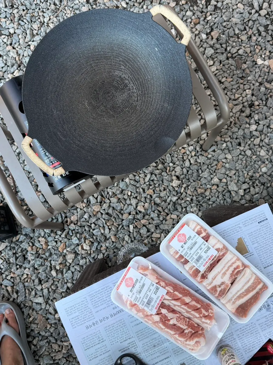 Pork belly and sausages grilled golden brown over charcoal