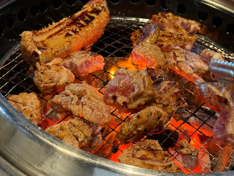 Cheongnyuok's marinated pork ribs grilling on the tabletop grill