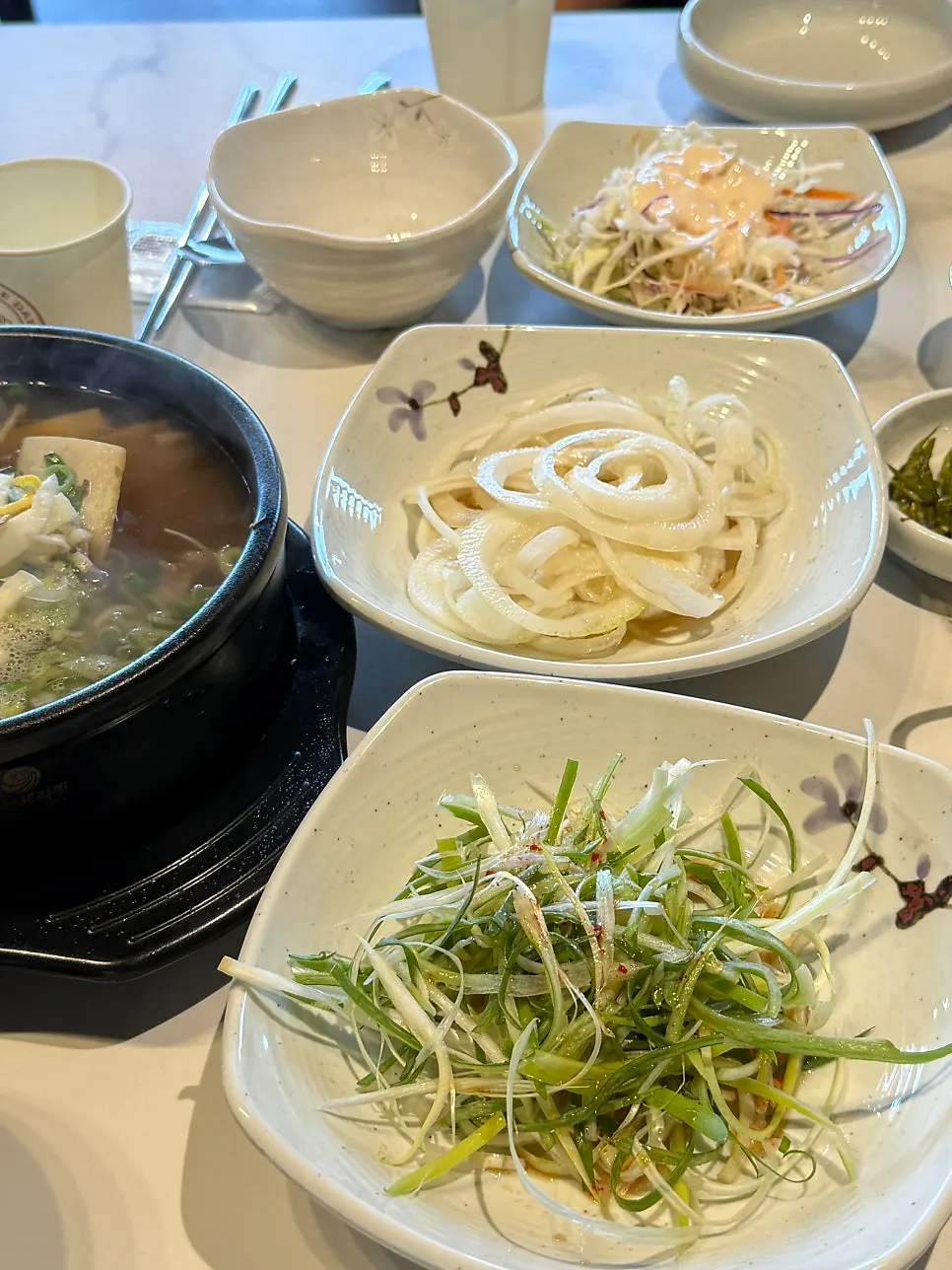 Basic side dishes including green onion kimchi and seasoned crab