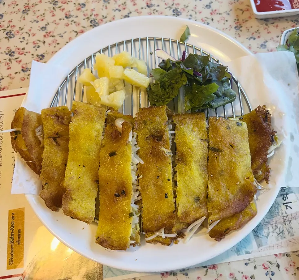 Crispy golden banh xeo shell packed with bean sprouts