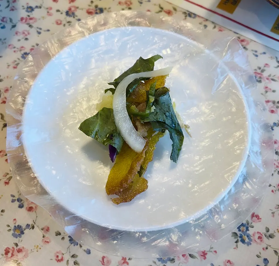 Cross-section of banh xeo filled with bean sprouts and meat