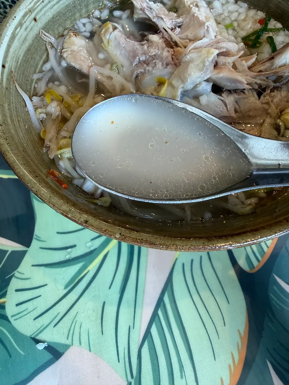 Chicken rice-crust pho served with drumstick and rice crust