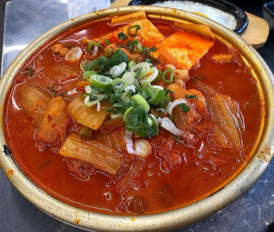 Kimchi stew served brimming in the pot