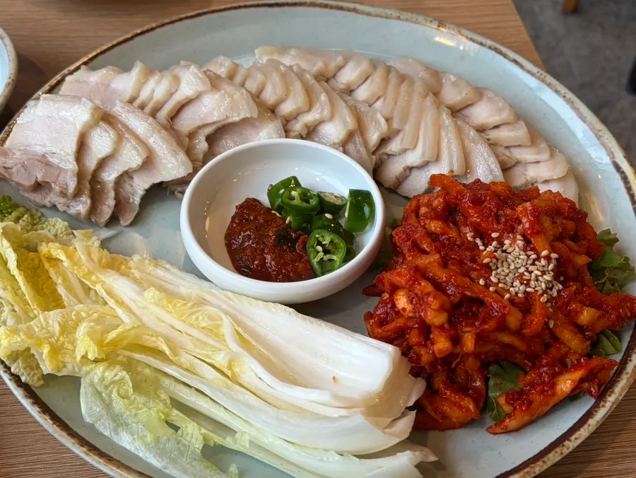 A piece of ogyeop bossam paired with bossam kimchi