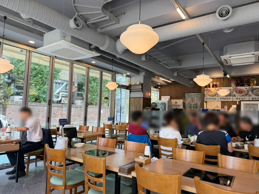 Interior of Cheongun Bossam Dangsan Branch with wood and gray tones