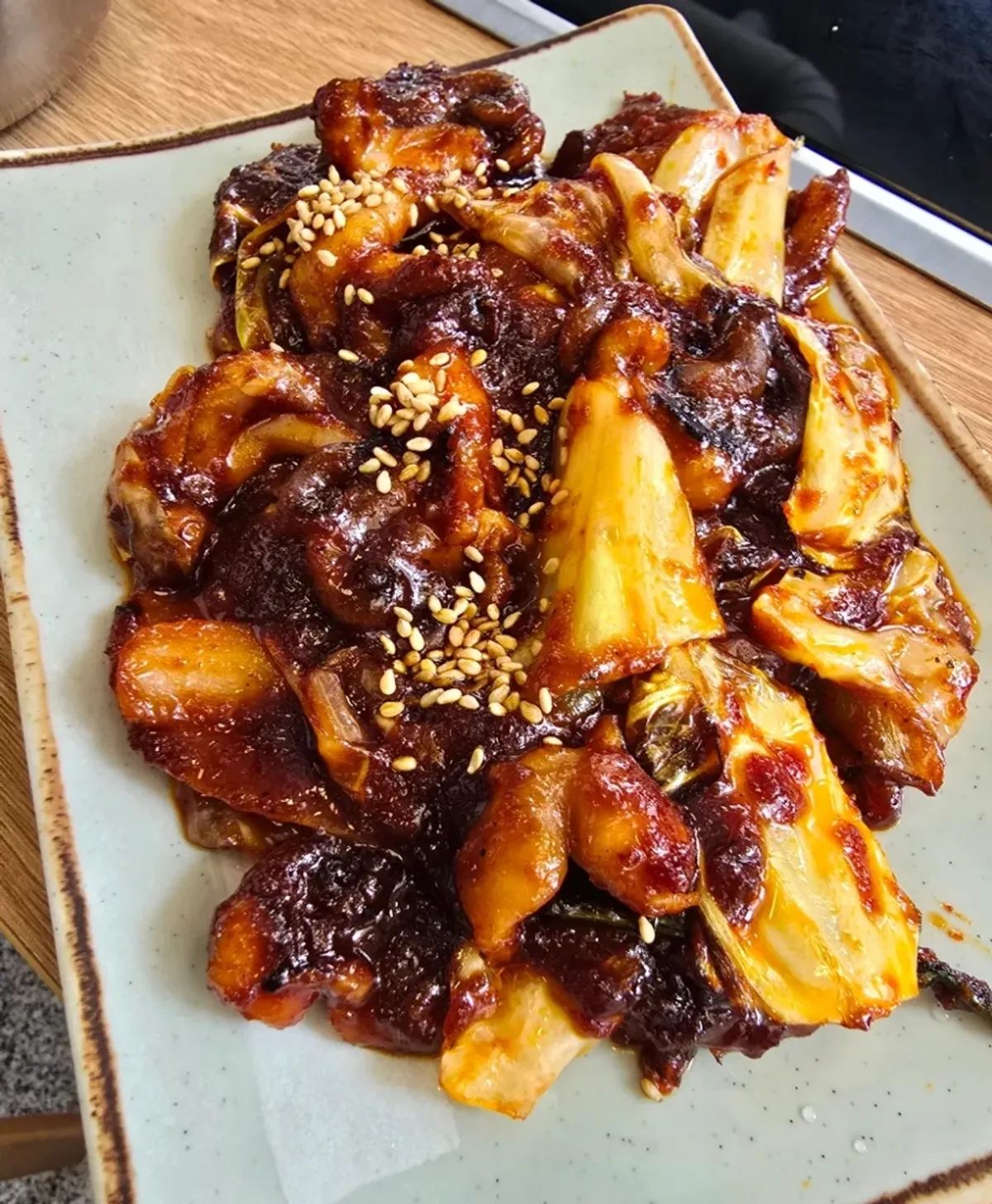 Red-sauced stir-fried octopus sprinkled with sesame seeds