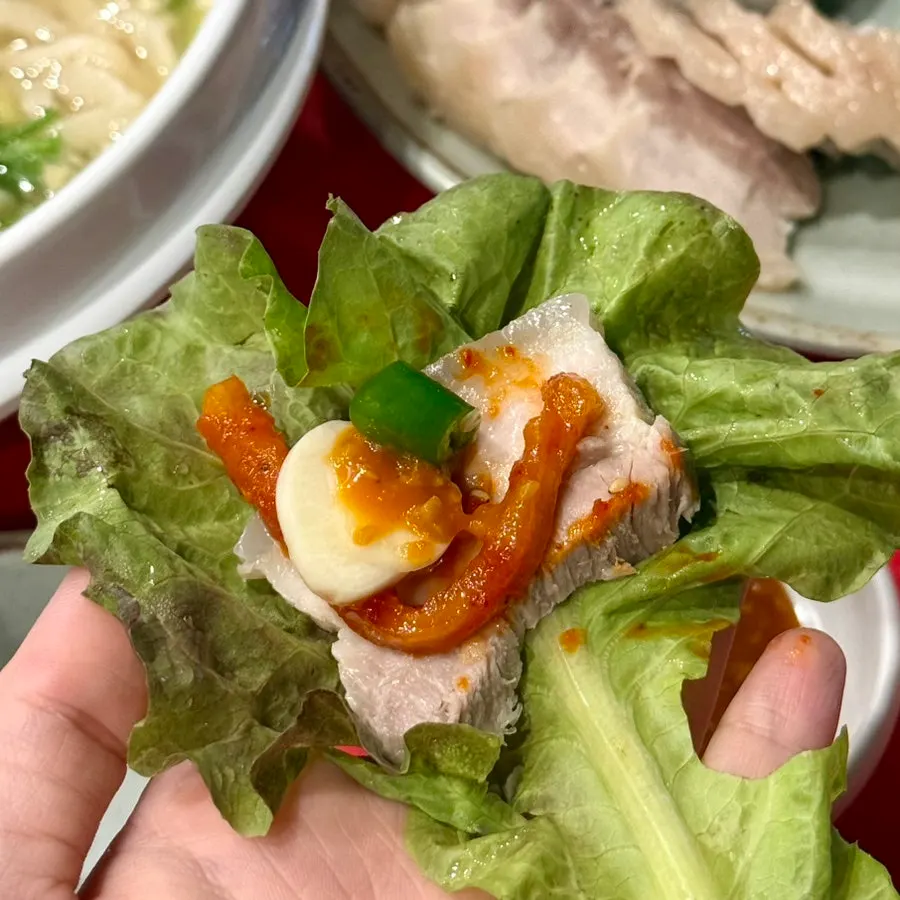 Spicy radish salad and cabbage served with bossam